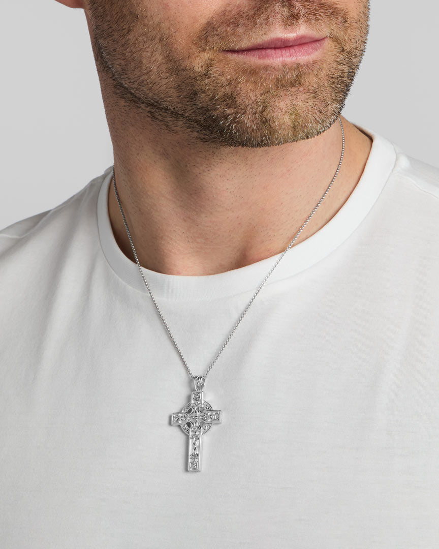 a male model wearing heavy silver celtic cross pendant from Solvar