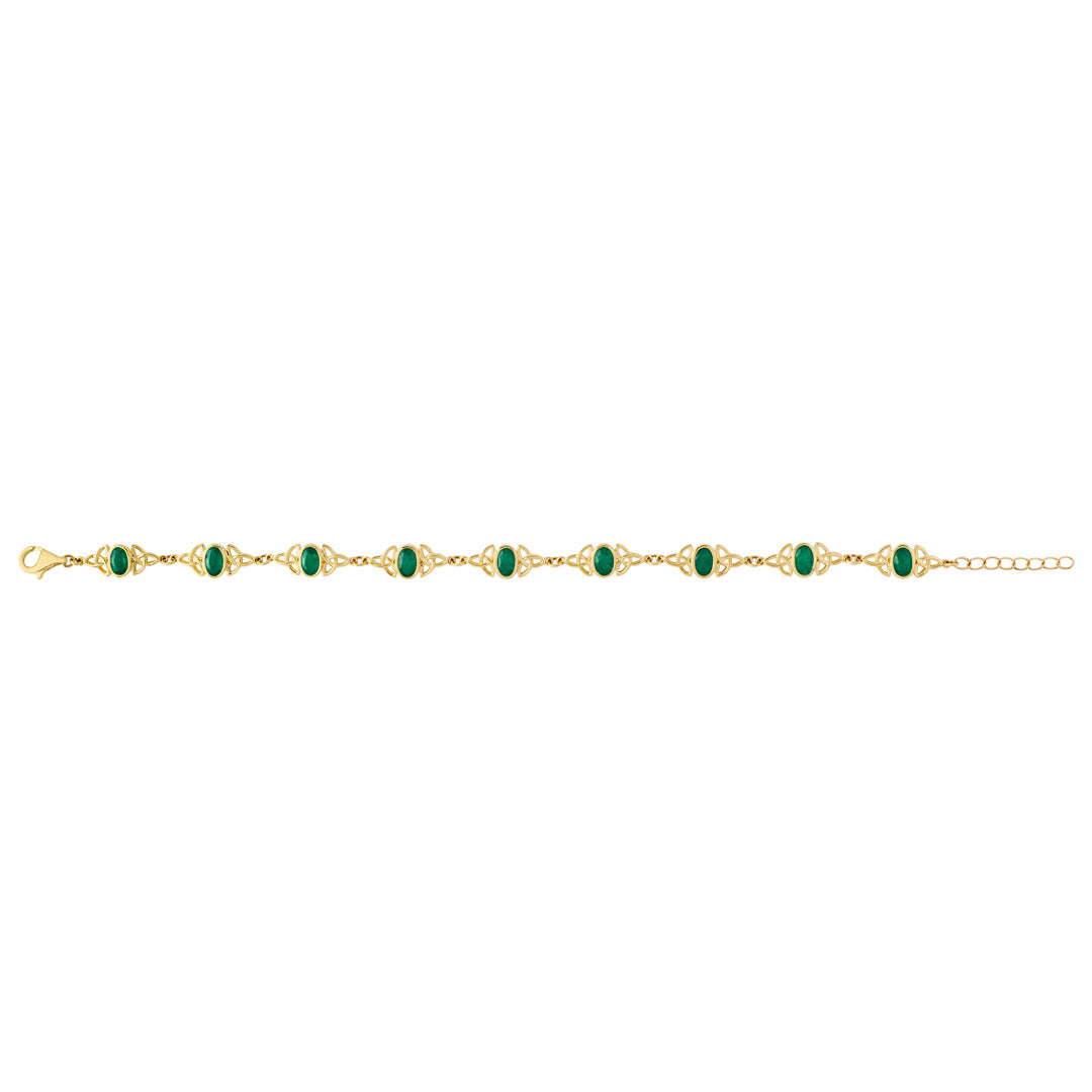 Product shot showing ladies emerald set Trinity Knot tennis bracelet laid out in its open state.