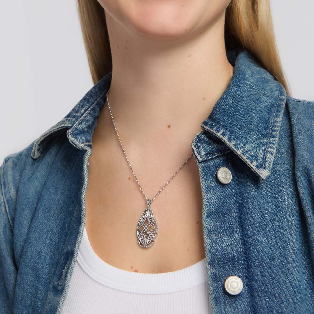 close-up image of large celtic knot necklace of a female model