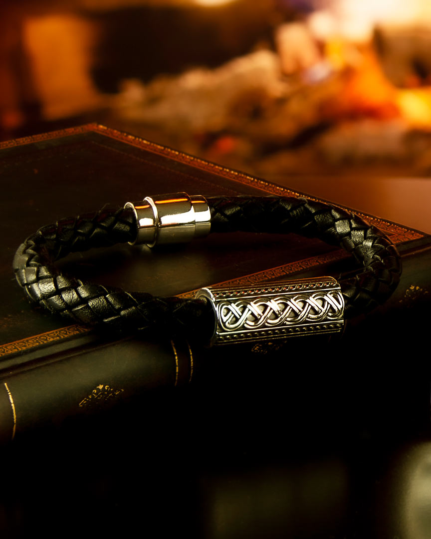 styled image of leather Celtic bracelet for men on open fire background