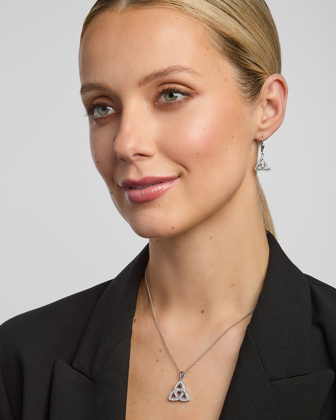 matching trinity knot necklace and earrings on a female model