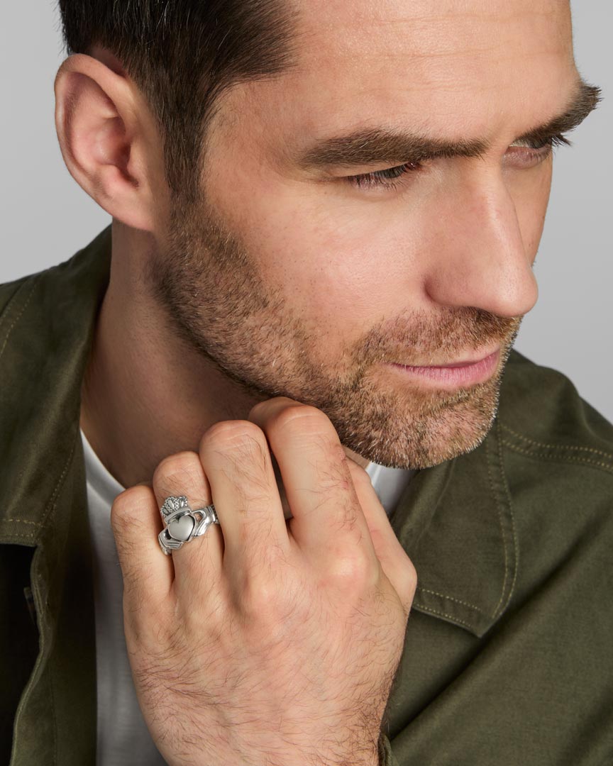 a model wearing men's heavy silver Celtic Claddagh ring from Solvar