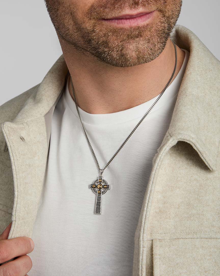 gold and silver large celtic cross pendant on a male model