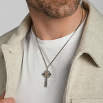 gold and silver large celtic cross pendant on a male model
