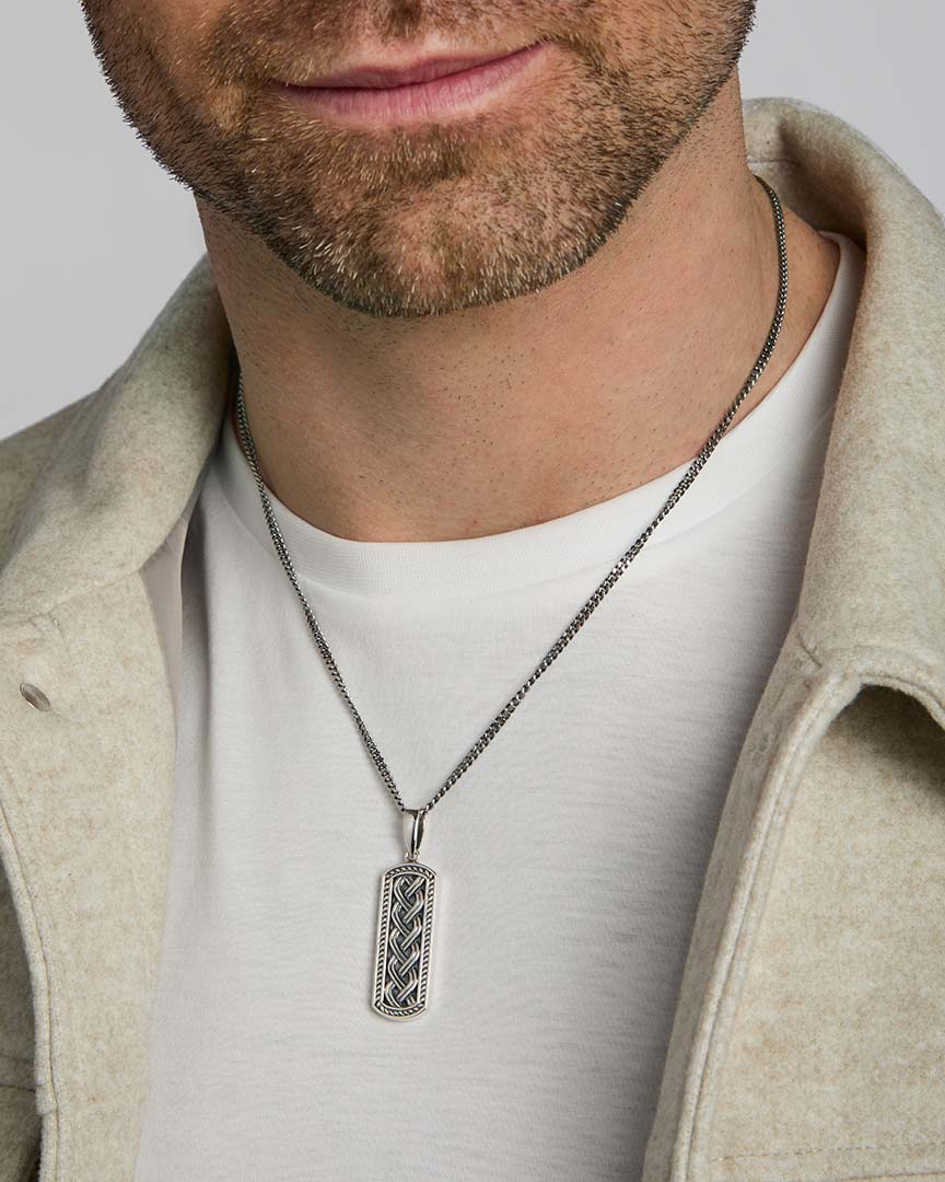 men's oxidised silver Celtic knot ingot pendant on a model