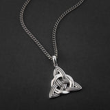 lifestyle image of large men's celtic knot pendant on a heavy silver flat curb chain 
