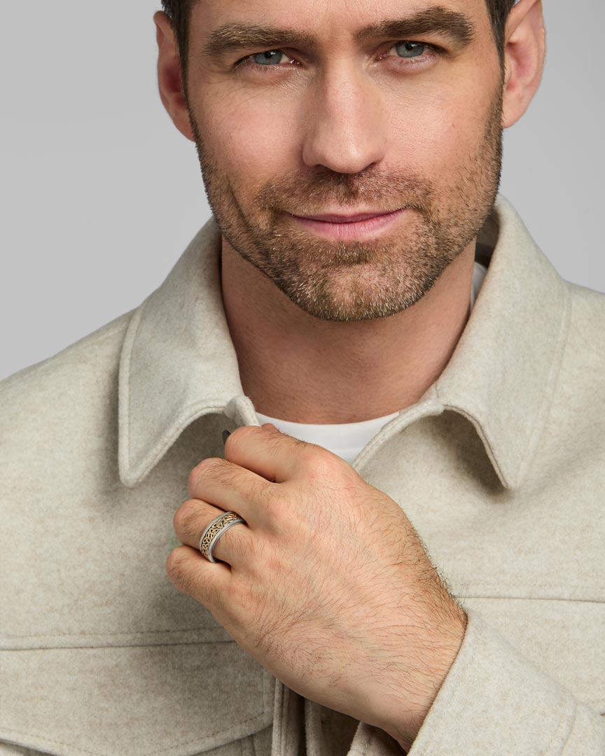 male model wearing gold and silver Celtic Trinity Knot band ring from Solvar
