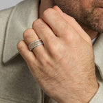 closeup image of mens gold and silver Celtic Trinity Knot band ring on a model