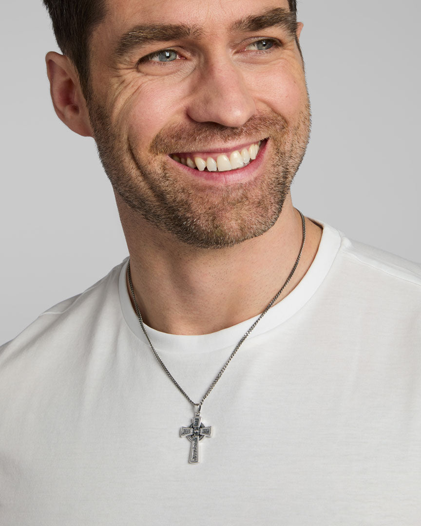 a male model wearing oxidised silver Celtic cross necklace from Solvar