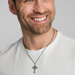 a male model wearing oxidised silver Celtic cross necklace from Solvar