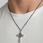 closeup image of men's oxidised silver Celtic Cross necklace on a model 