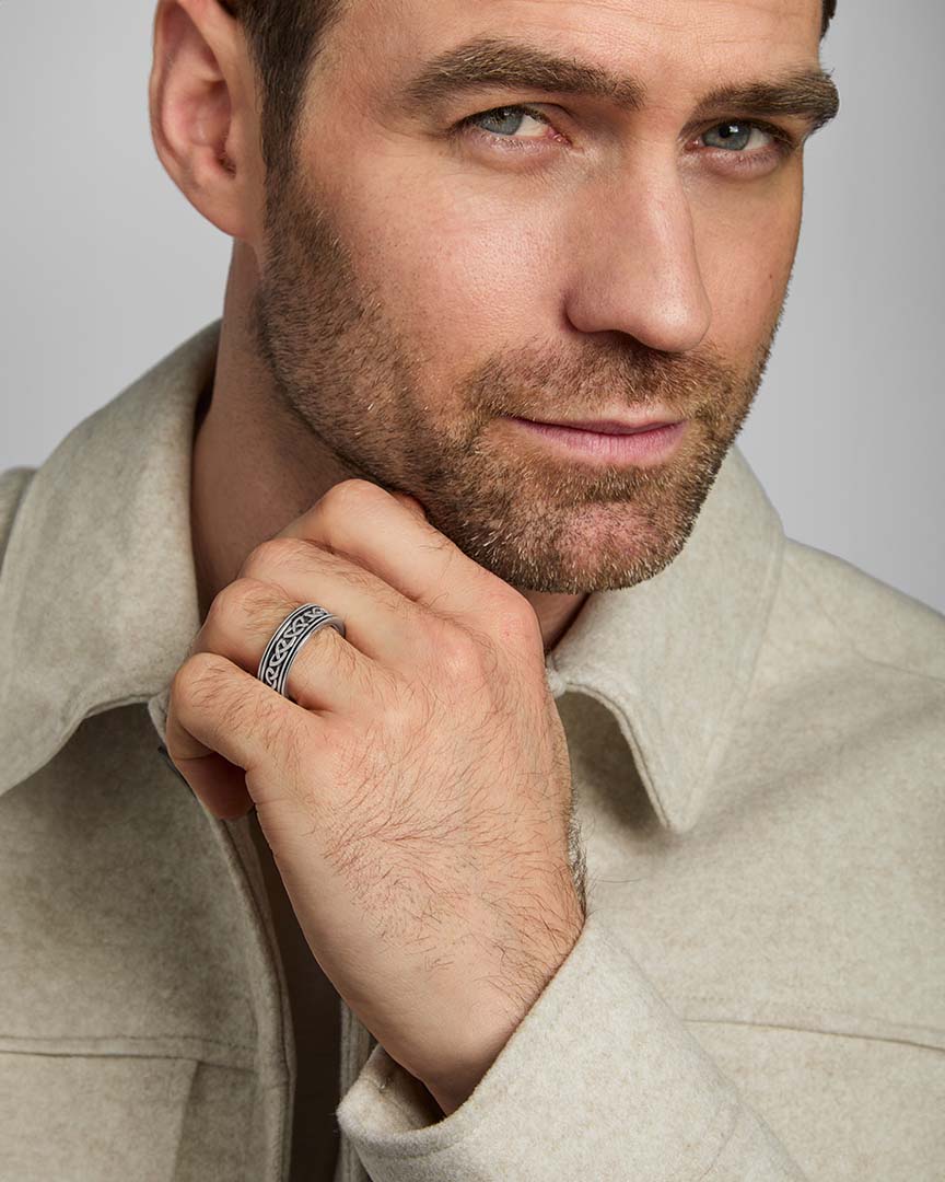 a male model wearing oxidised silver Celtic Knot band ring from Solvar