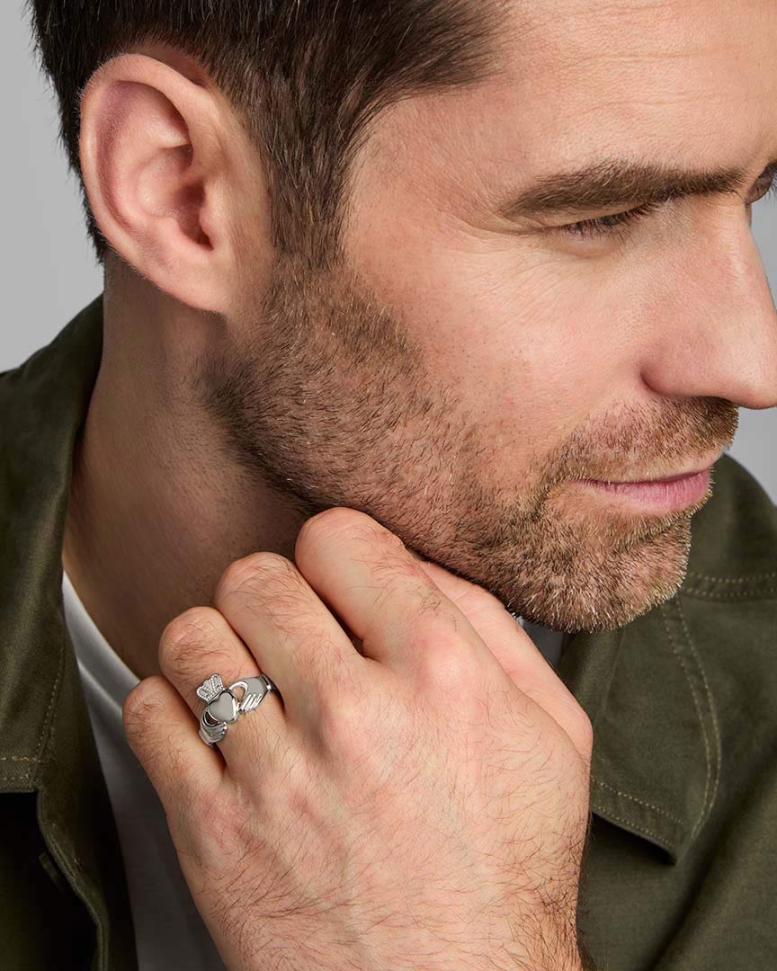 a male model wearing claddagh ring in silver