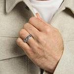 closeup image of mens silver claddagh band ring on a model