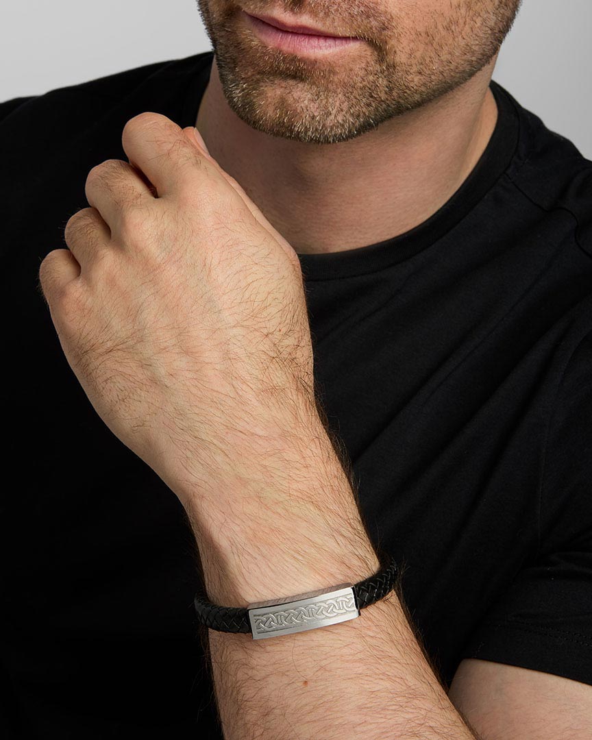 a male model wearing black leather wide Celtic bracelet from Solvar