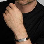 a male model wearing black leather wide Celtic bracelet from Solvar