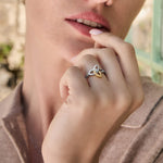 Close-up image mixed metal Celtic ring on a model outdoors.