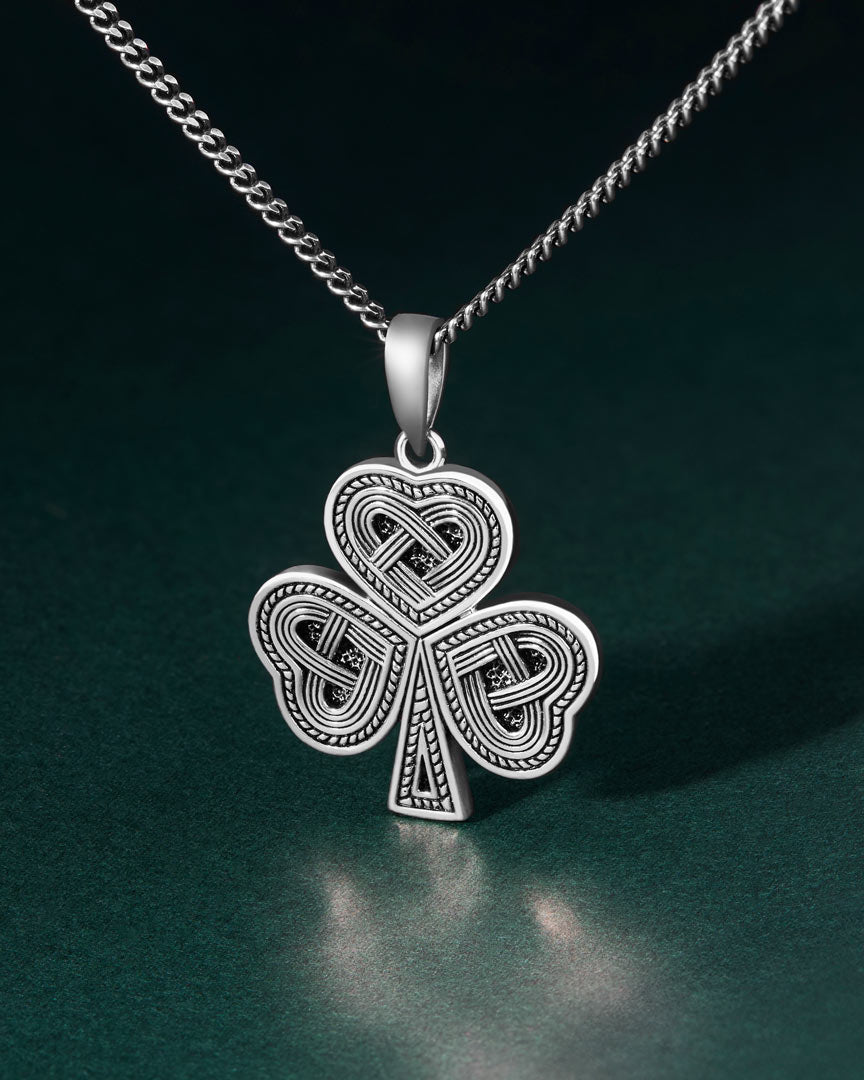 lifestyle image of oxidised silver Celtic Shamrock pendant for men
