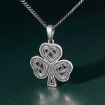 lifestyle image of oxidised silver Celtic Shamrock pendant for men