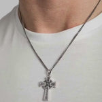 close-up video of a heavy celtic cross pendant on a male model in a white t-shirt