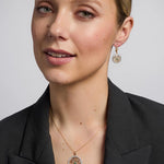 14K gold emerald round trinity knot earrings s33951 on a model 2