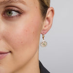 14K gold emerald round trinity knot earrings s33951 on a model 1