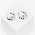 lifestyle image of chunky claddagh hoop earrings in silver