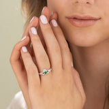 styled image of sterling silver claddagh emerald ring s2594 on a model 2