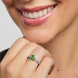 close-up image of green cubic zirconia silver Shamrock ring on a model 