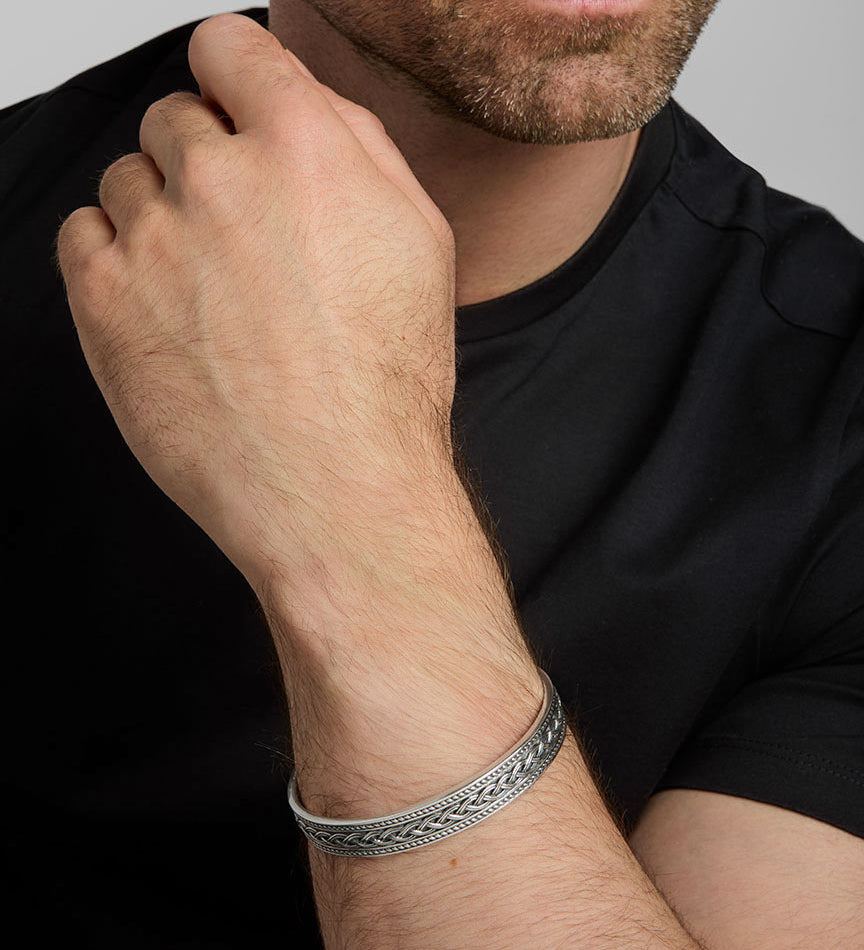 closeup image of men's heavy Celtic Knot bangle on a model