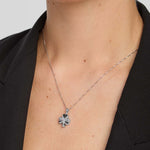 close-up image of  a female model wearing shiny silver Shamrock pendant 