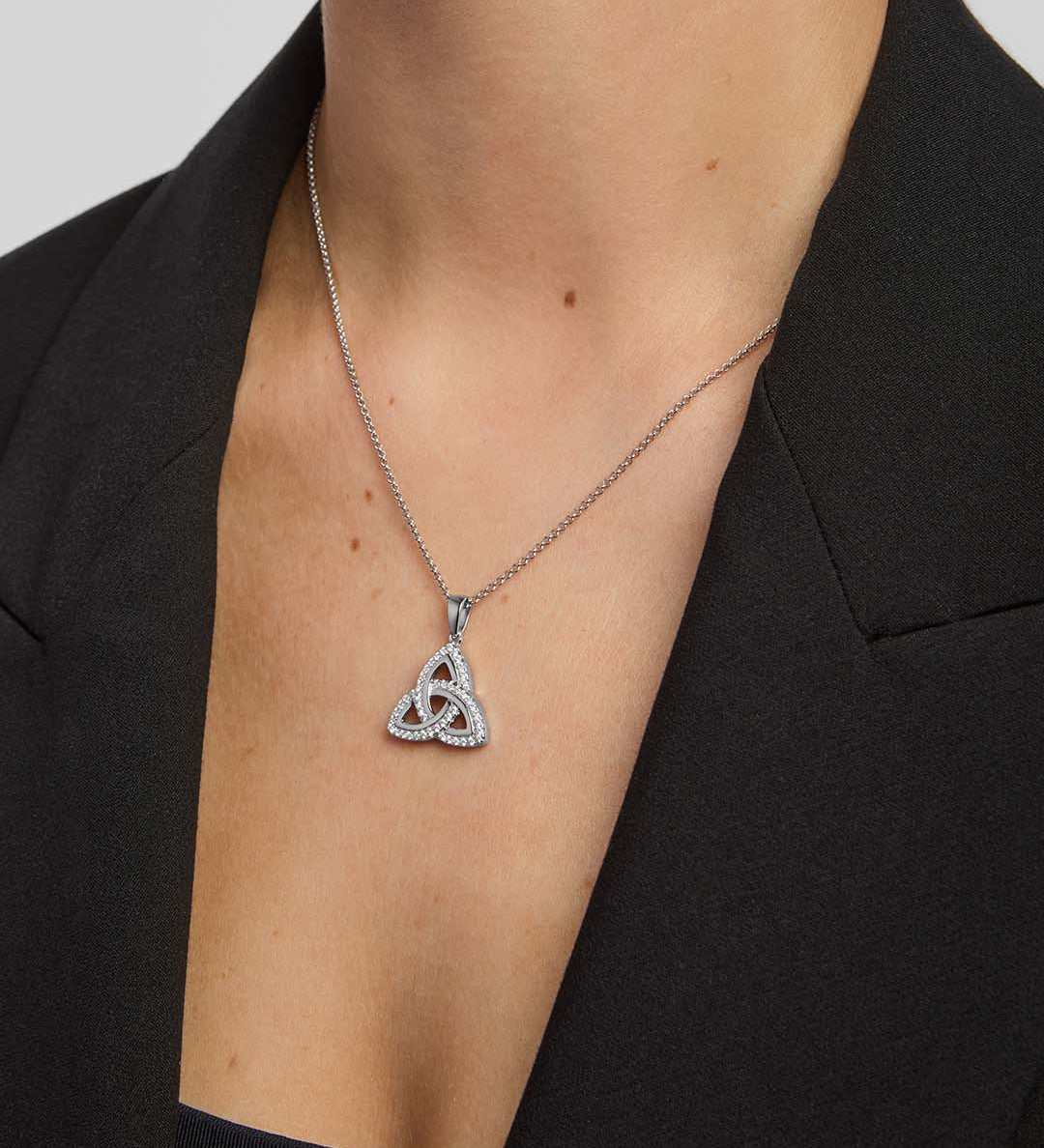 female model wearing cubic zirconia large Trinity Knot necklace in silver