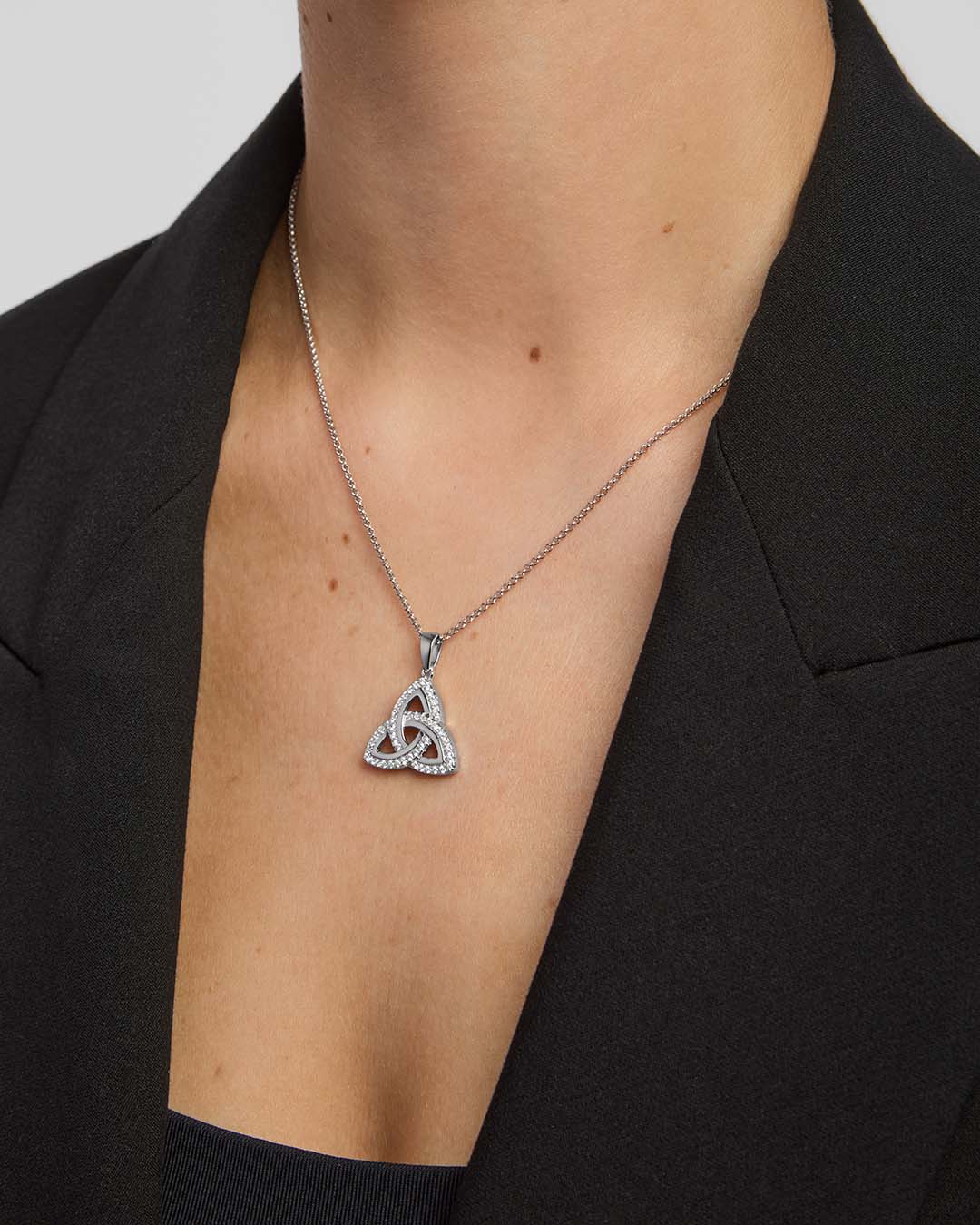 female model wearing cubic zirconia large Trinity Knot necklace in silver