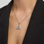female model wearing cubic zirconia large Trinity Knot necklace in silver