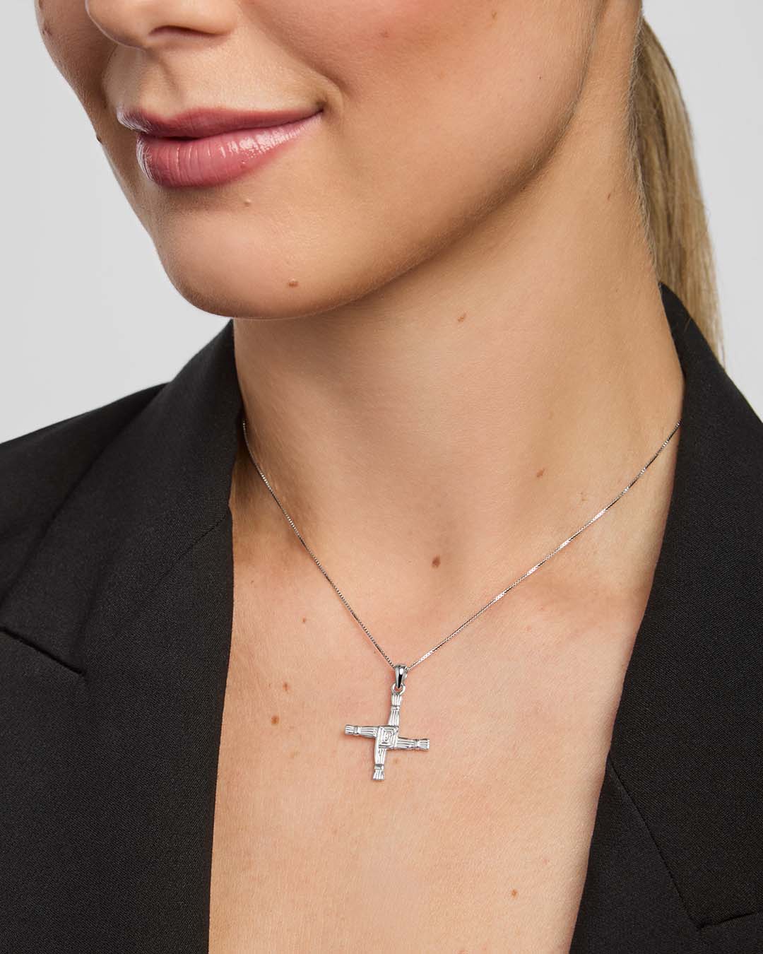 a female model wearing St Brigid's Cross pendant from Solvar