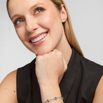 lifestyle image of a female model wearing green cubic zirconia trinity knot bracelet from Solvar