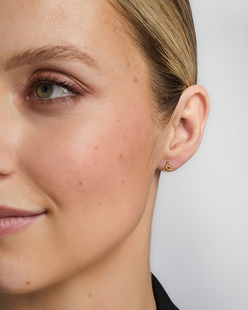 14K gold small trinity knot stud earrings s3077 on a model 1