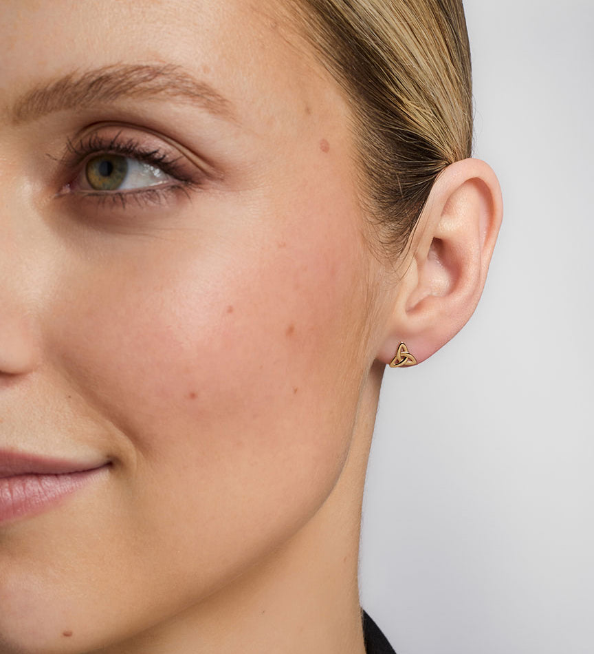 14K gold small trinity knot stud earrings s3077 on a model 1