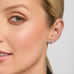 Close-up image of a woman wearing traditional Trinity Knot stud earring
