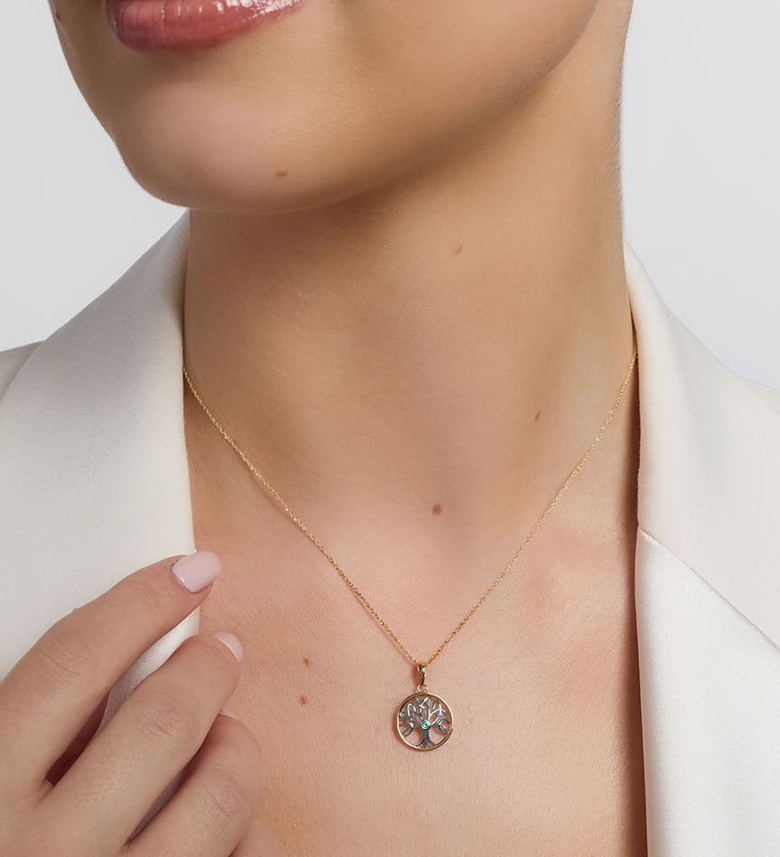 a model wearing tow tone gold Celtic tree of live pendant